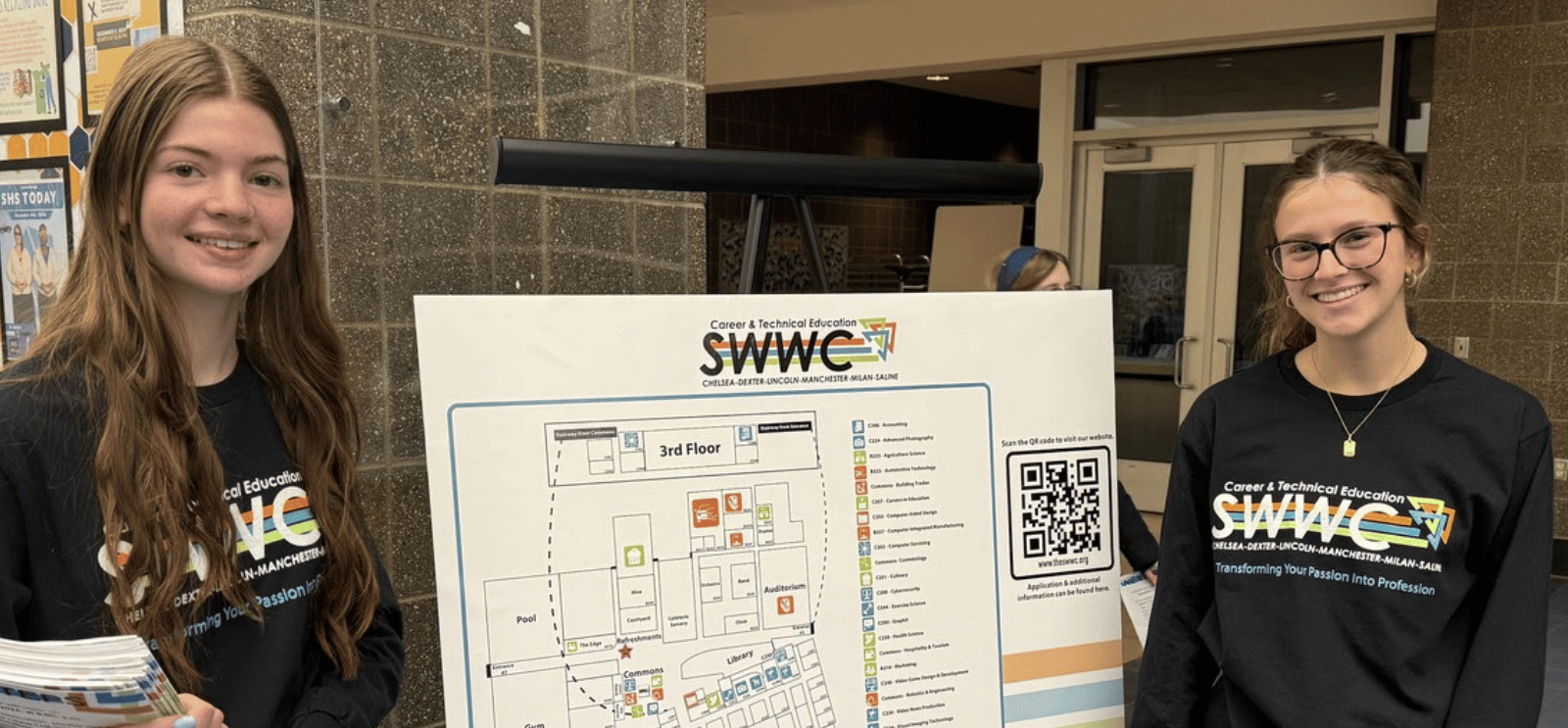 2 Students representing SWWC with a map