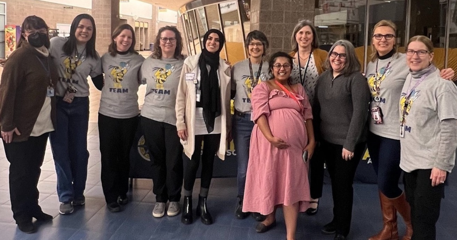 The EL Team and Admin for the District posing in the High School Commons