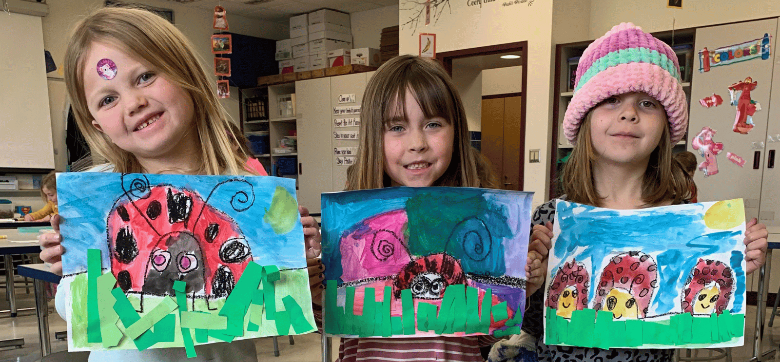 Students with ladybug artwork