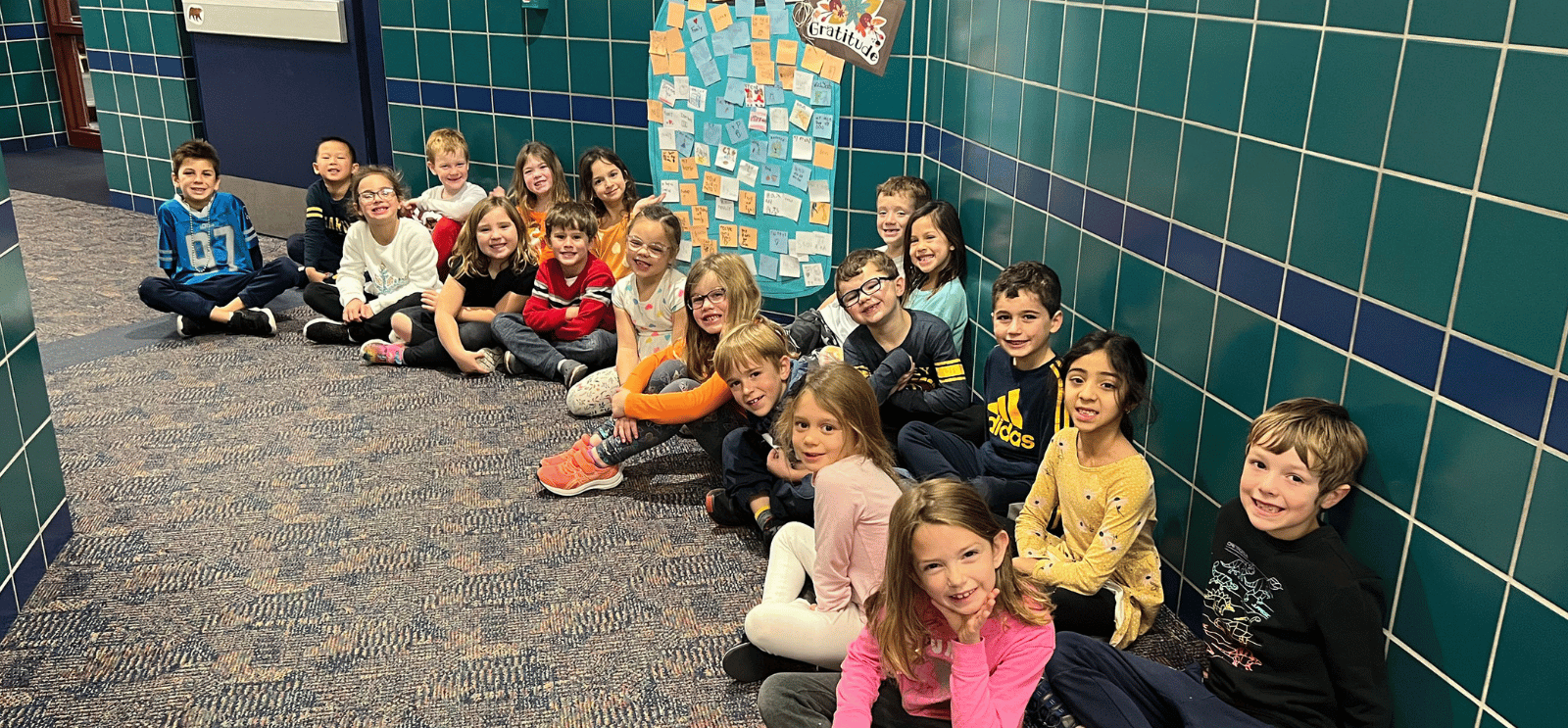 1st grade students by a gratitude jar